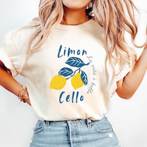 Cream Comfort Colors unisex shirt with yellow lemons and navy blue leaves, featuring “Limoncello” text and “La vita è bella” in script.