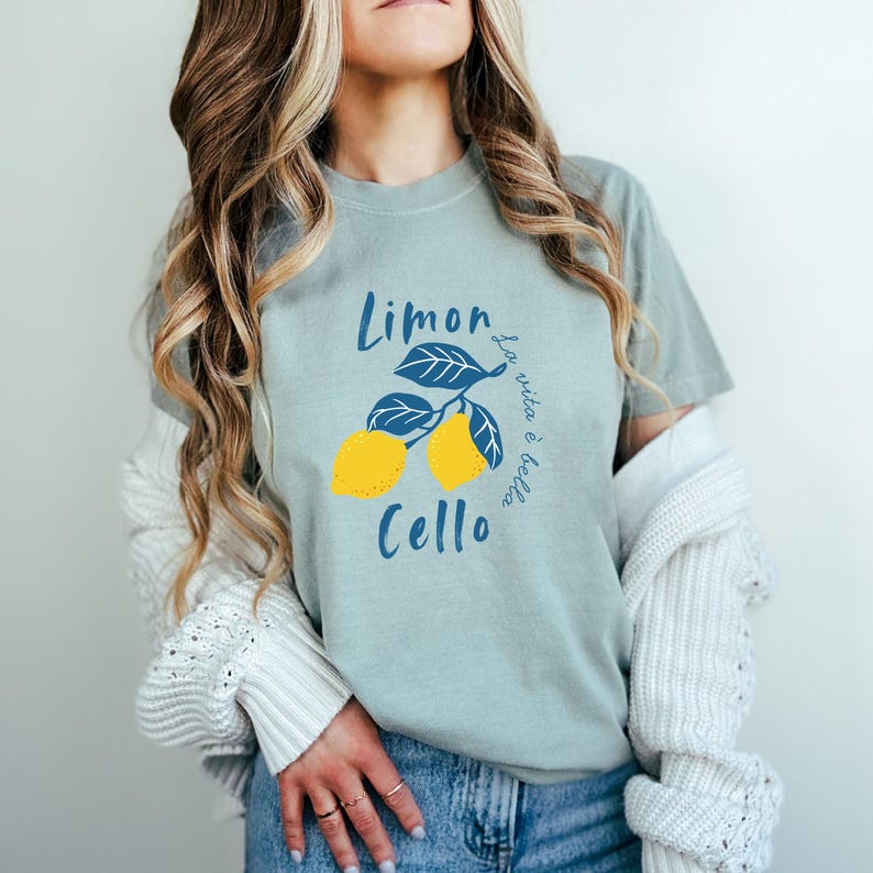 Bay Comfort Colors unisex shirt with yellow lemons and navy blue leaves, featuring “Limoncello” text and “La vita è bella” in script.