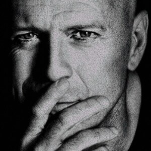 May include: Black and white portrait photograph of a man with a serious expression. He is looking down and his hand is covering his mouth.