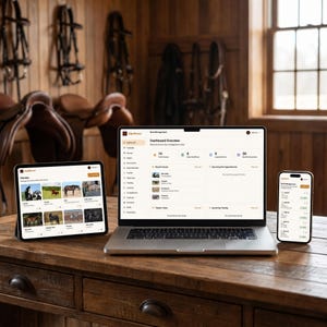 May include: A wooden desk displays a laptop, tablet, and smartphone, all showcasing a horse management software interface. The screens display data and images related to horses. The background features equestrian equipment and a wooden wall.