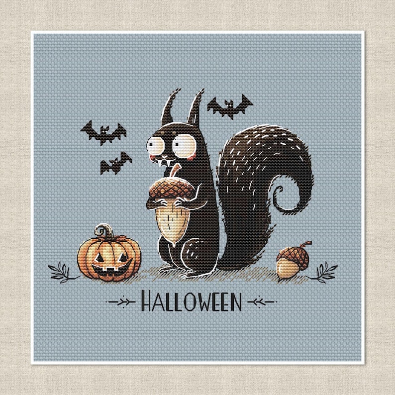May include: A cross-stitch design featuring a black squirrel holding an acorn, a jack-o'-lantern, and bats against a light blue background. The word "HALLOWEEN" is displayed below the squirrel. The design has a whimsical, cartoonish style.