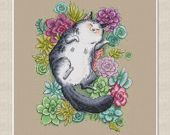 May include: Cross-stitch pattern featuring a gray and white cat lying amidst colorful succulents. The cat has a smiling expression. The succulents are in shades of green, pink, and purple, set against a neutral background.