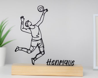 Escultura de voleibol con base de madera
