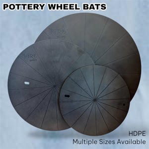 May include: Three black pottery wheel bats made of HDPE plastic. The bats have a circular shape with a center hole and radiating lines. The bats are labeled "The Fire Gallery".