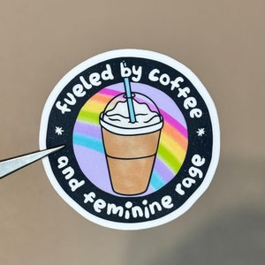 Klistermärke med "driven av iskaffe och feminin ilska"