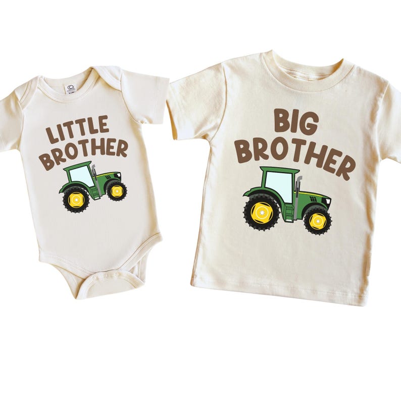 May include: Two cream colored shirts with brown text and a green tractor graphic. One shirt says "Little Brother" and the other says "Big Brother".
