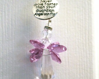 May include: A pink crystal angel car charm with the inscription "Never drive faster than your Guardian Angel can fly."