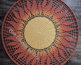 May include: A circular crochet wall hanging featuring a central golden yellow sunburst pattern that transitions into a dark orange and rust-colored petal design. The piece is mounted on a matching rust-colored hoop and includes the text 2PiRCrochetbyLara.