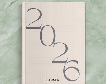 May include: A beige 2026 planner with the word "PLANNER" at the bottom. The numbers "2026" are in a dark gray font. The text "PERSONALIZED" and "15 COLORS" are at the top. The planner has a lined pattern.