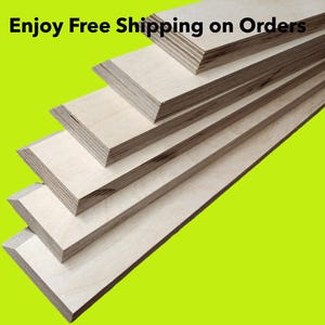 May include: Stack of five unfinished wood boards with beveled edges. The boards are arranged in a staggered pattern, with the top board extending furthest to the right. The boards are a light brown color and have a smooth, polished surface. The background is a bright green.