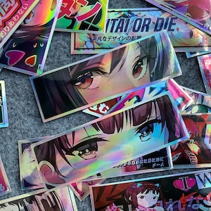 Puede incluir: Una colecci&oacute;n de pegatinas hologr&aacute;ficas con ojos de estilo anime y texto japon&eacute;s. Las pegatinas son coloridas e iridiscentes, con un efecto arco&iacute;ris.