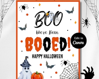 May include: A white printable sign with orange borders featuring a ghost, a pumpkin, and bats. The sign says "Boo! We've Been Booed! Happy Halloween." and "Edit in Canva".