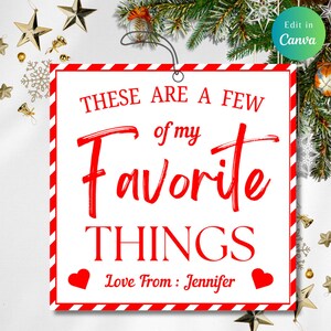 May include: A square Christmas ornament with a white background and a red border. The text "THESE ARE A FEW of my FAVORITE THINGS" is written in red. The bottom of the ornament says "Love From: Jennifer" with two red hearts.
