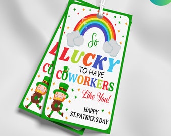 May include: Two St. Patrick's Day gift tags with a white background and green border. The tags feature a rainbow, leprechaun illustrations, and the text "So Lucky to Have Coworkers Like You!" and "Happy St. Patrick's Day". Each tag is 2 x 3.5 inches.