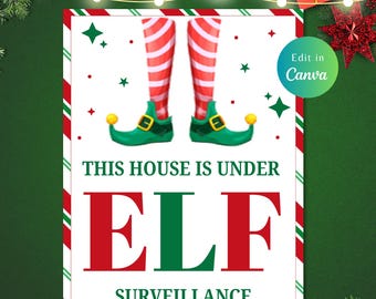 May include: A white sign with red and green stripes around the border. The sign has a pair of elf legs with red and white striped stockings and green shoes with yellow points. The text on the sign reads "This house is under ELF SURVEILLANCE".