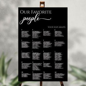May include: A black and white seating chart with the text "OUR FAVORITE people" in a script font. The chart lists names alphabetically, with each name followed by a number. The words "YOUR SEAT AWAITS" are also visible.