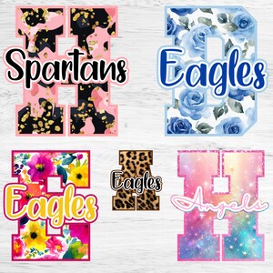 May include: Five varsity-style letters featuring diverse patterns: a pink and black camo H with gold flecks labelled Spartans, a blue rose D labelled Eagles, a floral E labelled Eagles, a leopard print A labelled Eagles, and a galaxy H labelled Angels.