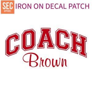 May include: Red iron-on decal patch with the text "COACH Brown" in a varsity-style font.