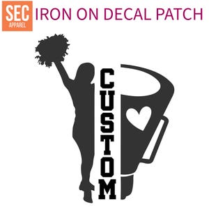 May include: Iron-on decal patch featuring a silhouette of a cheerleader holding pom-poms with the word "CUSTOM" written vertically in black text.