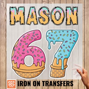 May include: Iron-on transfer with the name "MASON" in a waffle cone font, and the numbers "67" designed as donuts with sprinkles. The bottom of the image reads "IRON ON TRANSFERS".