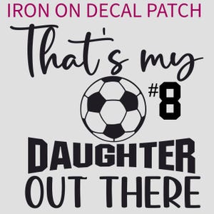 May include: Black and white iron-on decal patch with a football and the text "That's my #8 daughter out there".