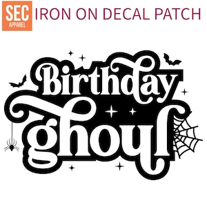 May include: Black and white iron-on decal patch with the text "Birthday Ghoul" in a spooky font. The design includes bats, stars, and a spider web.