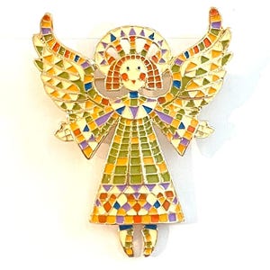 May include: A colorful angel brooch with a gold-tone outline. The angel features a mosaic design with wings, a halo, and a dress in shades of green, orange, purple, and yellow. The brooch is a decorative accessory.