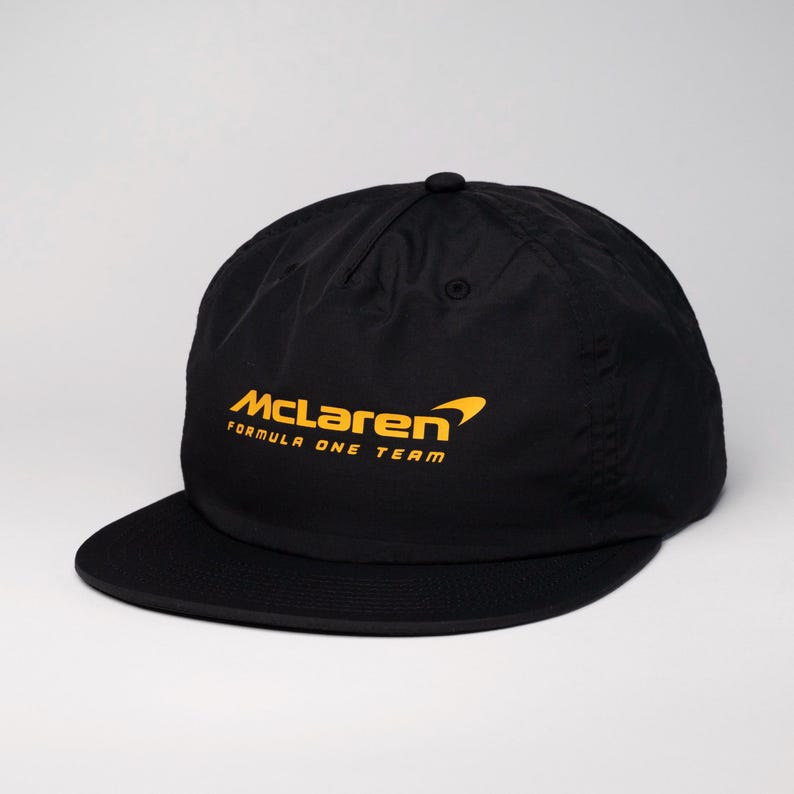 May include: Black baseball cap with a yellow McLaren Formula One Team logo.