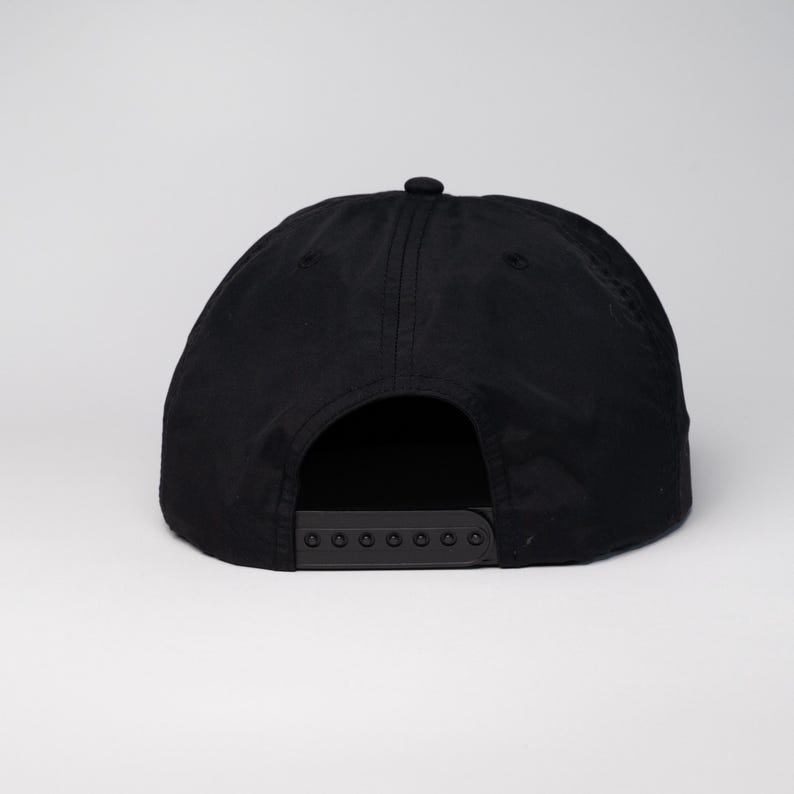 May include: Black baseball cap with a black adjustable strap in the back.