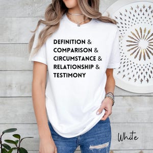 May include: White t-shirt with the words "DEFINITION & COMPARISON & CIRCUMSTANCE & RELATIONSHIP & TESTIMONY" printed in black. The word "White" is written in a script font in the bottom right corner.