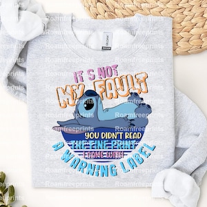 May include: Gray sweatshirt with a blue Stitch character from Lilo & Stitch. The text on the shirt reads "It's not my fault you didn't read the fine print I came with a warning label."