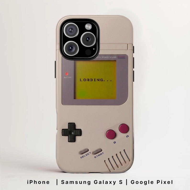 May include: A beige phone case designed to resemble a retro handheld gaming device. The case features a screen displaying "LOADING...", along with buttons and a directional pad. The case is compatible with iPhone, Samsung Galaxy S, and Google Pixel phones.