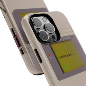 May include: Beige phone case with a retro video game design. The case features a screen displaying "LOADING..." and a red battery indicator. The camera lenses are visible, and the case has black accents.