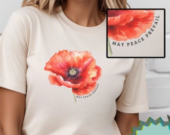 May include: A beige t-shirt with a red poppy flower graphic and the text "May Peace Prevail" around the flower.