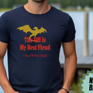 May include: A navy blue t-shirt with a yellow dragon graphic and the text "The DM is My Best Fiend I Said What I Said".