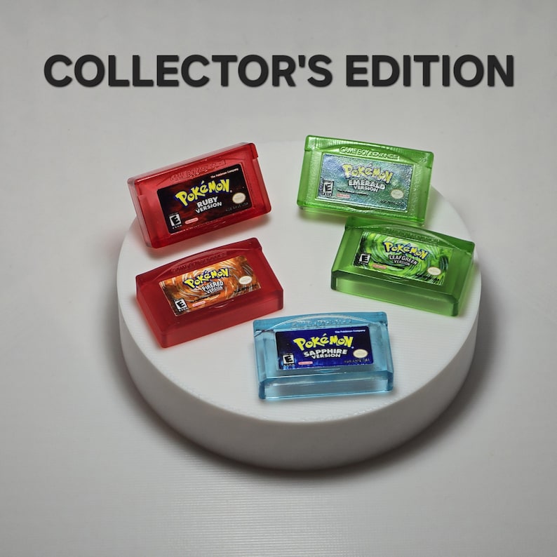 May include: A collection of five translucent Game Boy Advance cartridges labeled COLLECTOR'S EDITION. The set includes red Ruby and FireRed versions, green Emerald and LeafGreen versions, and a blue Sapphire version, all featuring Pok&eacute;mon branding.