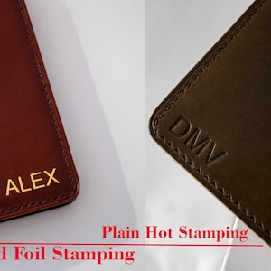 May include: Two leather wallets with different types of hot stamping. The wallet on the left has "ALEX" in gold foil stamping. The wallet on the right has "DMV" in plain hot stamping.