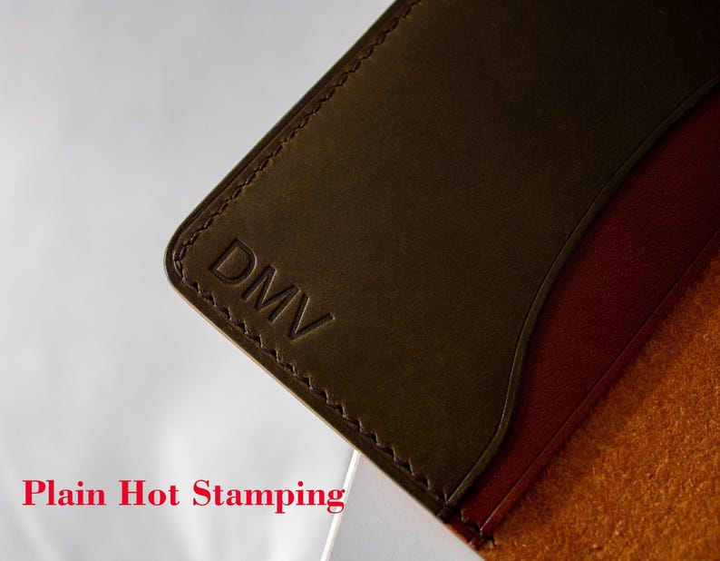 May include: A brown leather wallet with a stitched edge and the word "DMV" embossed on the front. Plain Hot Stamping.