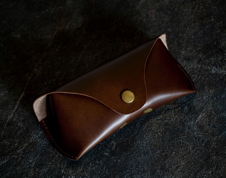 Handmade leather glasses case is made of Italian full-grain vegetable tanned leather “Buttero”, proven by time and practice, hand stitching using Japanese linen threads gives reliability and confidence that the seam will never come apart.

The case is made of smooth 1.4mm thick genuine leather, hand stitched with linen threads, and the brass clasp is incredibly strong.
Inside the case has a leather bridge, made of 3 layers of leather
