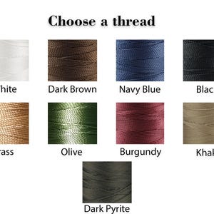 May include: A selection of thread spools in various colors, including white, dark brown, navy blue, black, brass, olive, burgundy, khaki, and dark pyrite.
