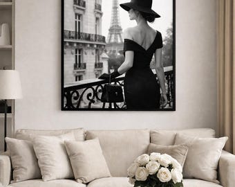 May include: Monochrome framed print featuring a woman in a black dress and hat, with the Eiffel Tower in the background. The print hangs above a beige sofa with cushions and a round coffee table, creating a stylish interior.