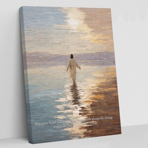 May include: An oil painting on canvas depicts a figure in a white robe walking on water towards the horizon. The artwork features a serene landscape with a warm color palette of blues, yellows, and oranges. Text at the bottom reads: "May your heart always be light, your faith always be strong and your soul forever be at peace."