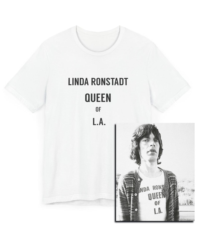 May include: White t-shirt with black text that reads "Linda Ronstadt Queen of L.A."