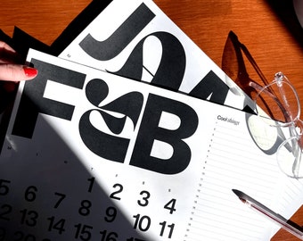 May include: A black and white calendar with the letters "F&B" in large, bold font. The calendar shows the month of February with the numbers 1 through 11 visible. The text "Cool things" is written on the right side of the calendar.