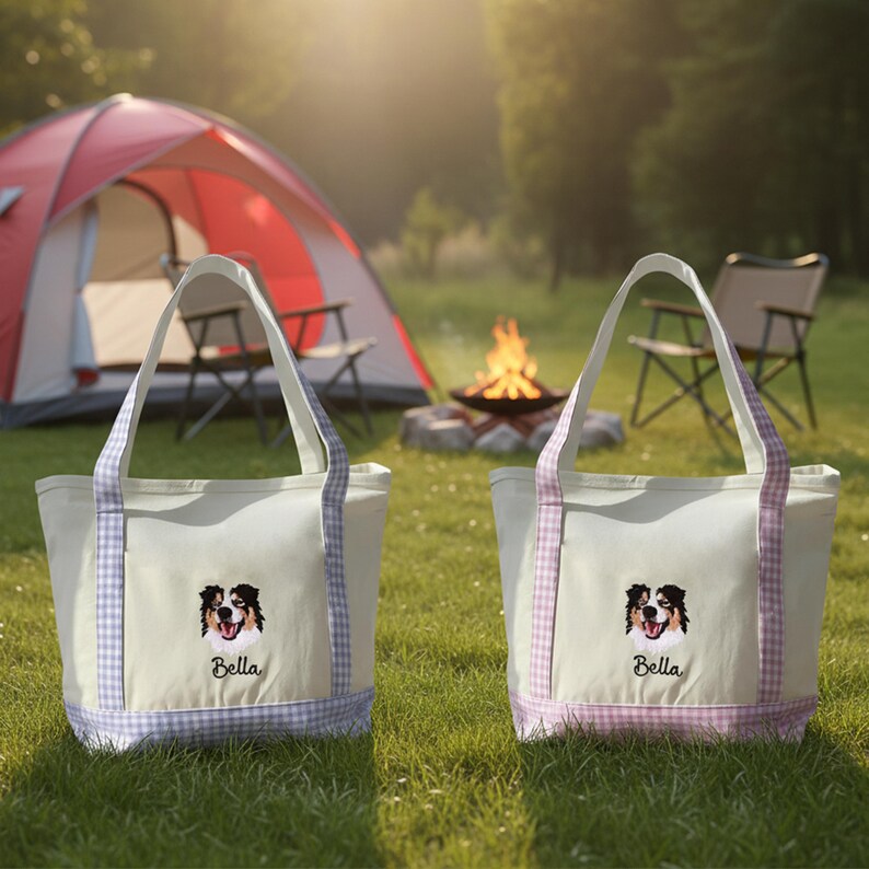 May include: Two off-white canvas tote bags featuring an embroidered Australian Shepherd dog face and the name Bella in black script. Each bag has light purple or pink gingham patterned fabric trim on the handles and base.