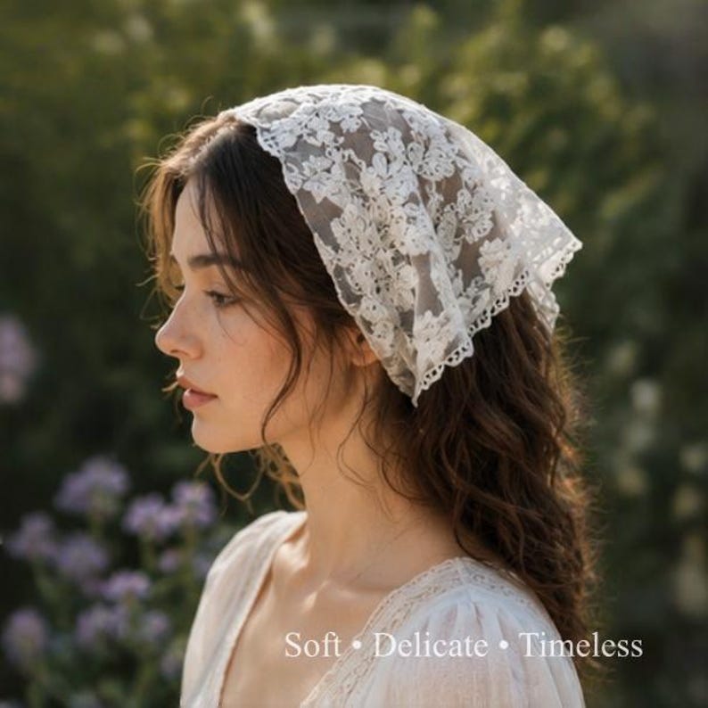 May include: A white lace headscarf with floral patterns. The headscarf is worn on the head. The image also includes the text "Soft &bull; Delicate &bull; Timeless".