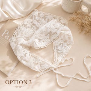May include: A white lace collar with floral and leaf patterns. The collar has a tie closure and is displayed on a neutral surface. The text "OPTION 3" is visible at the bottom of the image.