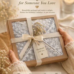 May include: A gift box with a cream-colored ribbon and a tag that reads "Handmade with love." The box contains a white lace fabric and dried flowers. Text on the image says "A Thoughtful Gift for Someone You Love."