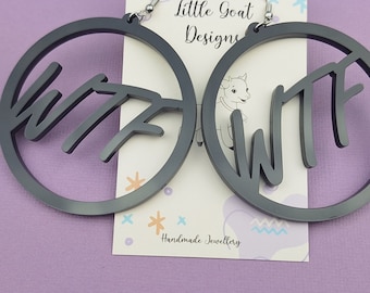 May include: A pair of black acrylic hoop earrings with the word "WTF" written in a stylized font. The earrings are handmade and feature a silver hook closure.