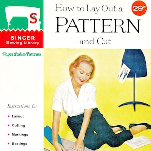 May include: A vintage Singer Sewing Library booklet titled How to Lay Out a Pattern and Cut, Book No. 105. The cover features an illustration of a person cutting paper patterns on a blue surface, with a dress form and sewing instructions listed.